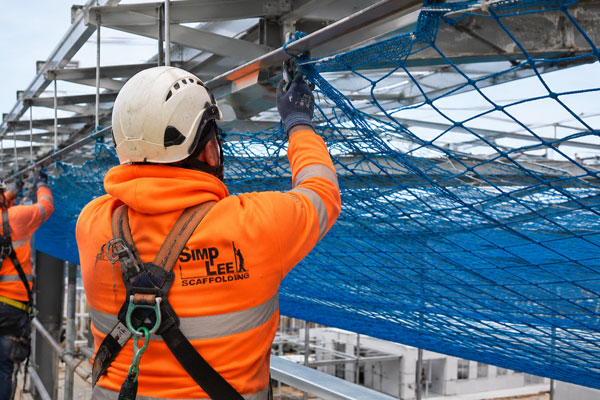 Safety net installation using scaffold access on a commercial site