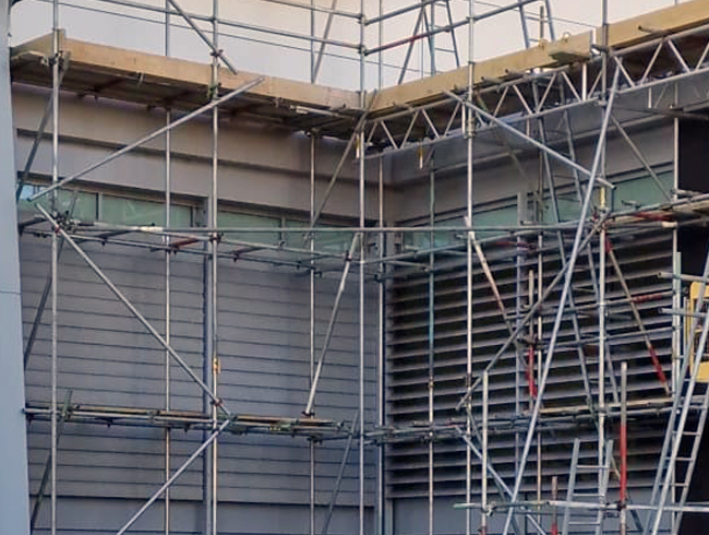 Installing safety netting on industrial building